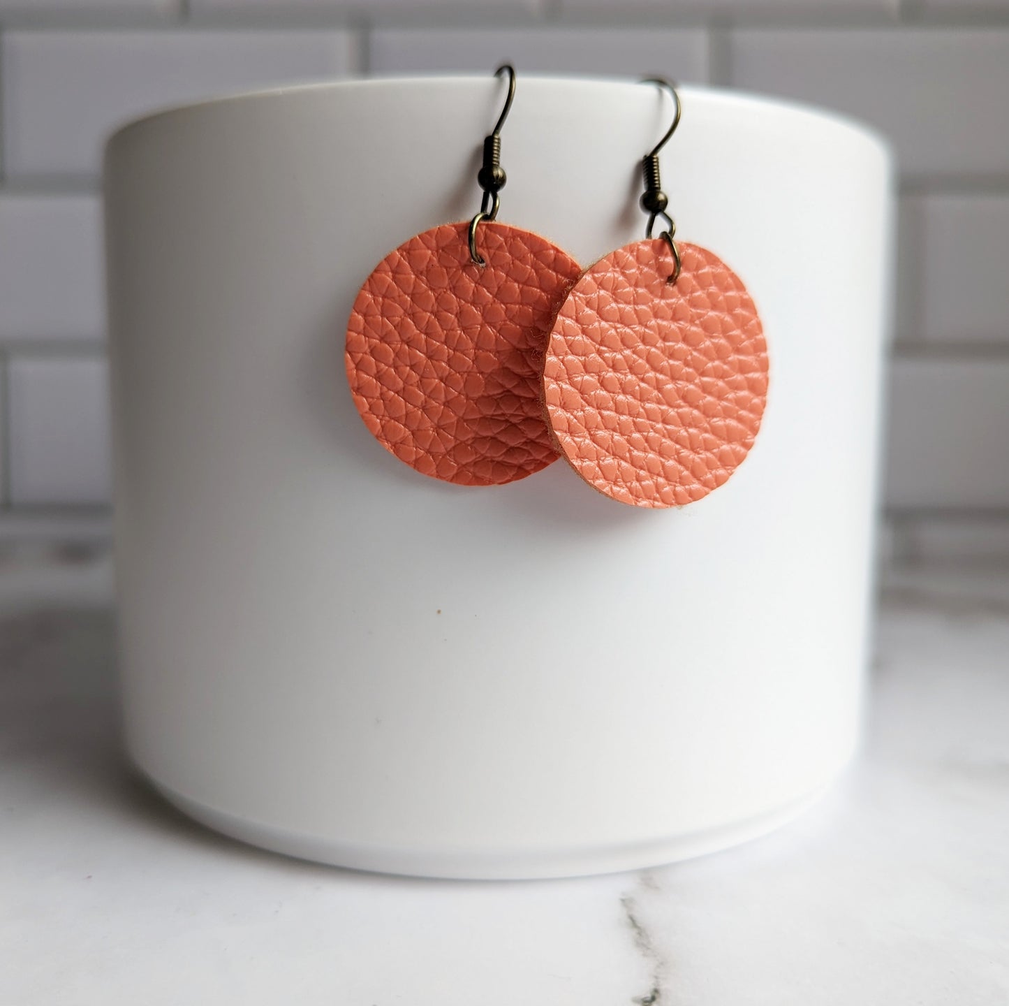 Orange round faux leather earrings